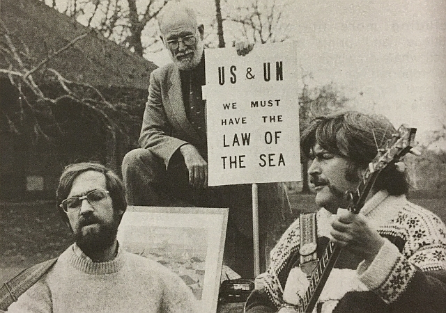 Image of protesters holding sign and singing songs at a rally held by Connectictu Cetacean Society in Hartford, Connecticut in 1982.